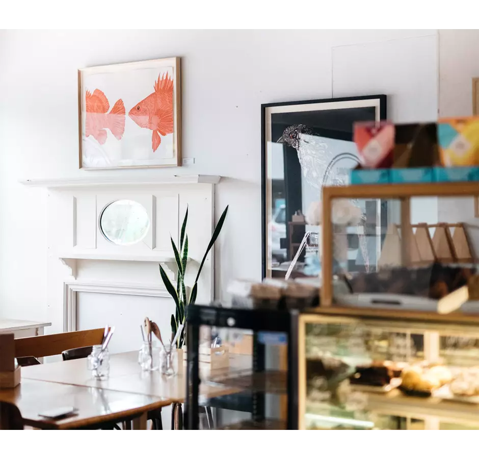 Inside Lincoln Pantry. Art work on the walls and cabinet showing delicious baked goods.