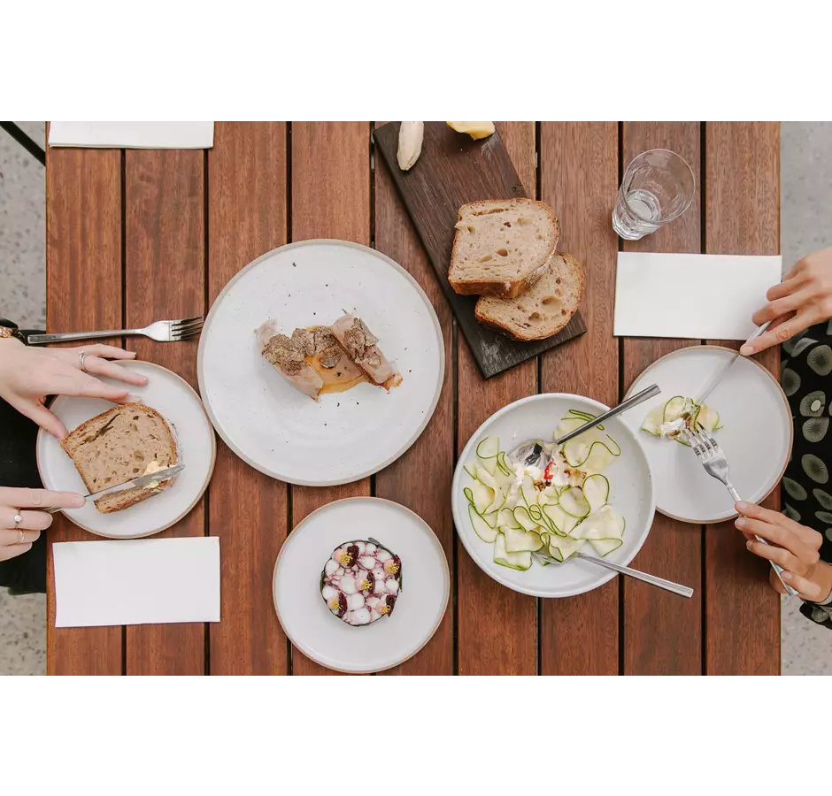 Birds eye view of dinner plates filled with food at Tussock Hill Vineyard Christchurch.