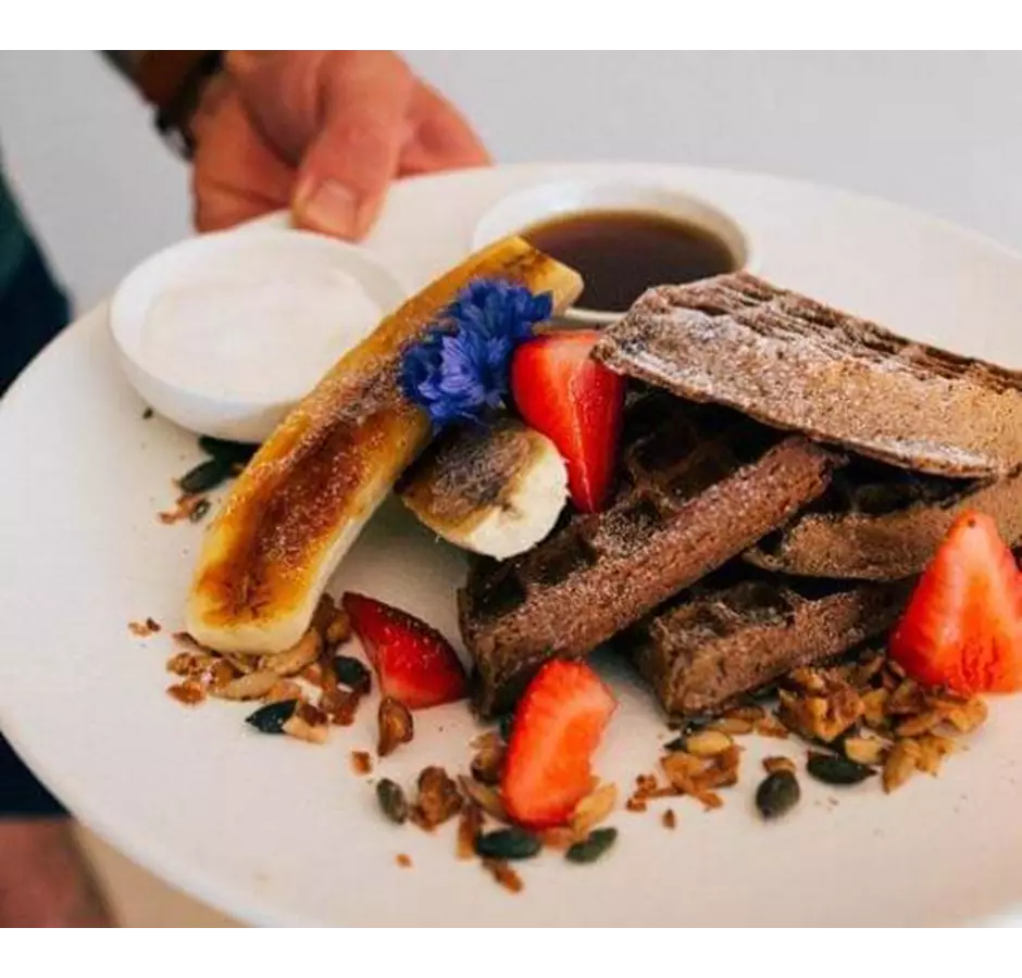 Plate of waffles with banana, berries and yoghurt at the Alpine Grind Mid Canterbury.