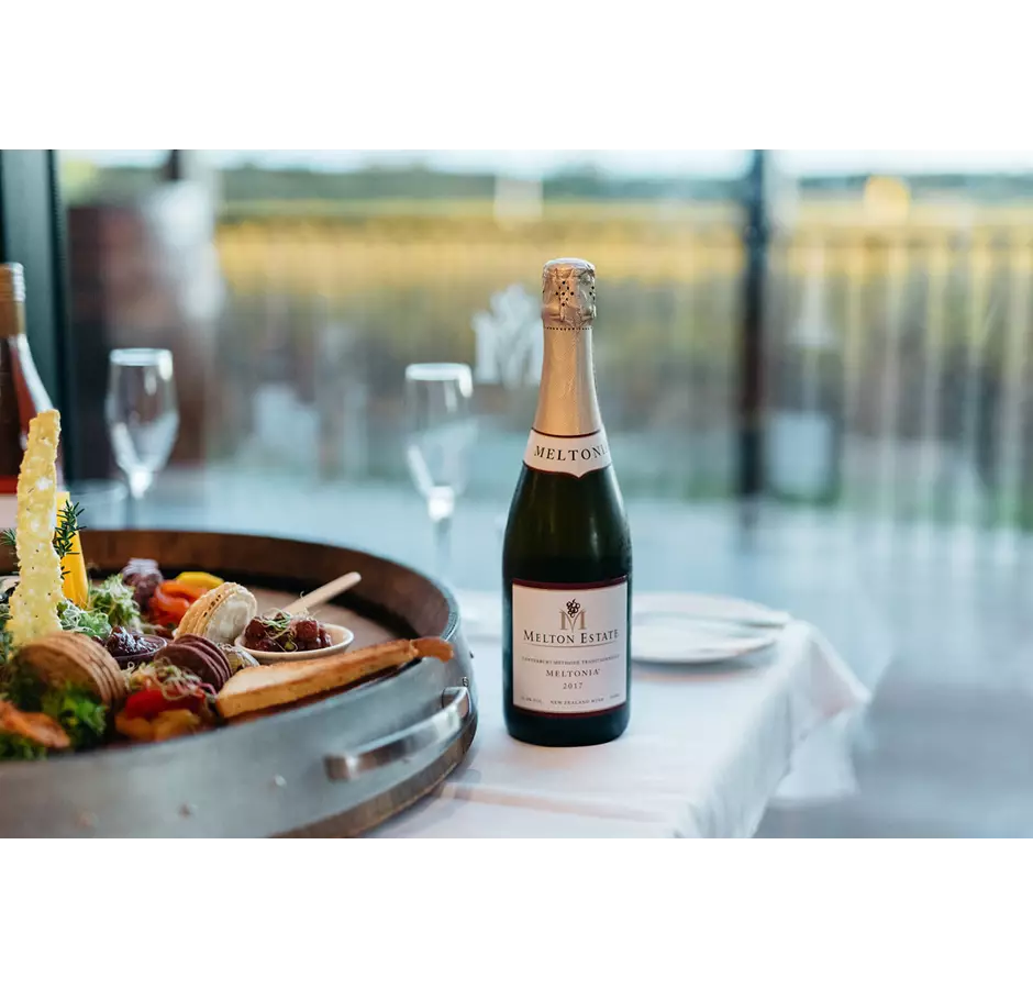 Sparkling wine bottle and platter of nibbles at Melton Estate Winery.